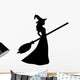 Young witch with a broom silhouette Wall Decal