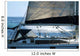 sailboat with a whale splash in background Wall Mural