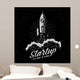 Rocket takes off startup symbol in retro vintage style. Launched spaceship logo. Textures and background on separate layers. Wall Mural