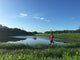 Male runner on path around lake Wall Mural