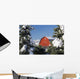 Snow covered red barn, evergreens, mountains Wall Mural