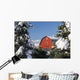 Snow covered red barn, evergreens, mountains Wall Mural