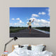 Man running away fast downhill Wall Mural