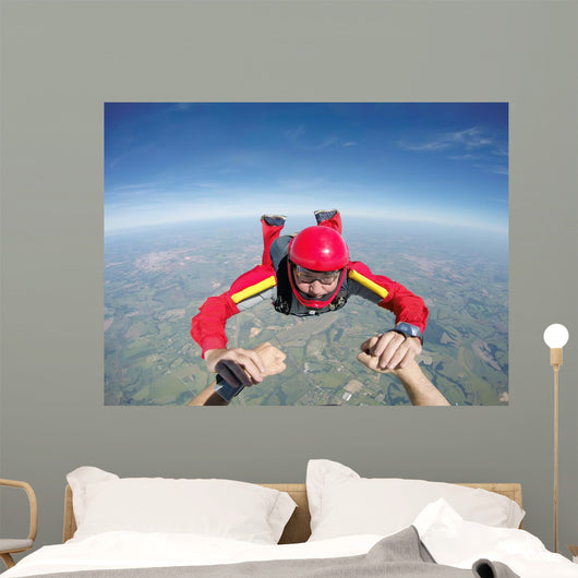 Skydiving senior man holding hands Wall Mural