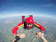 Skydiving senior man holding hands Wall Mural