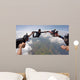 A group of friends holding hands teamwork skydiving Wall Mural