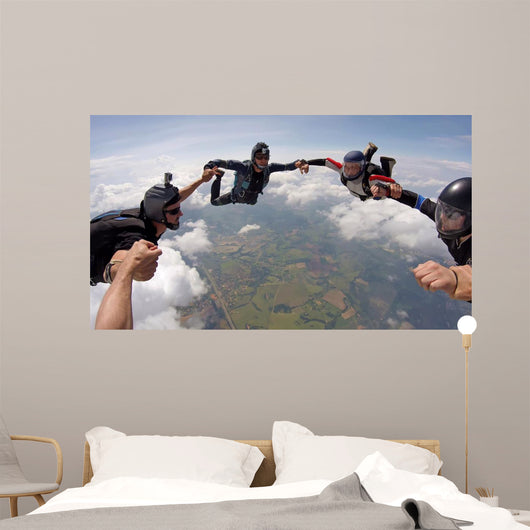 A group of friends holding hands teamwork skydiving Wall Mural