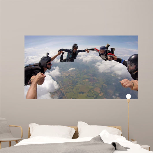 A group of friends holding hands teamwork skydiving Wall Mural