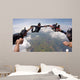A group of friends holding hands teamwork skydiving Wall Mural