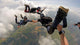 Skydiving point of view. Young and middle aged friends having fun Wall Mural