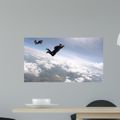Skydiving Cloudscape Wall Mural shown on a wall