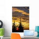 Silhouette of two evergreen trees, sunrise Wall Mural