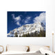Snow covered mountain peak, blue sky, clouds Wall Mural