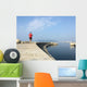 Man running along harbor sea wall Wall Mural