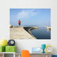 Man running along harbor sea wall Wall Mural