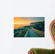 Senja island at orange sunset. Wooden pathway on the rocky beach Wall Mural