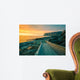 Senja island at orange sunset. Wooden pathway on the rocky beach Wall Mural