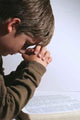 young boy praying over his bible Wall Mural