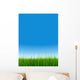 green grass over a clear blue sky without clouds as background Wall Mural