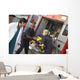 Paramedics and doctor unloading patient from ambulance Wall Mural