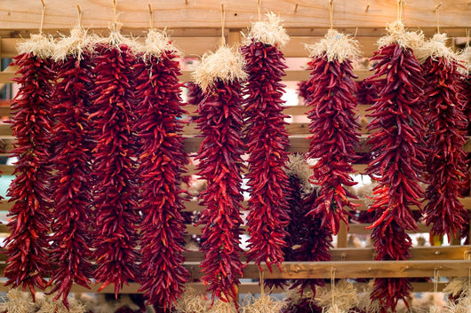Chili peppers hanging on Santa Fe marketplace, New Mexico Wall Mural