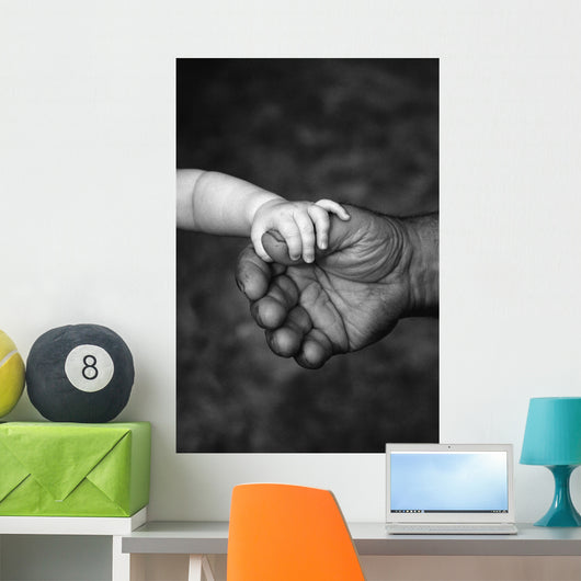 Baby's Hand Holding On To Adult Hand Wall Mural