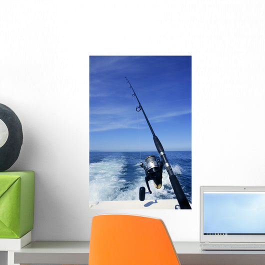 Fishing rod and reel on boat, fishing in blue ocean Wall Mural