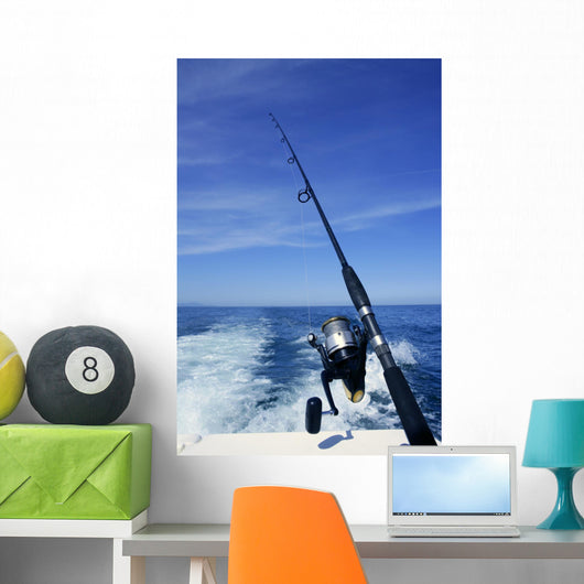 Fishing rod and reel on boat, fishing in blue ocean Wall Mural