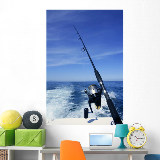 Fishing rod and reel on boat, fishing in blue ocean Wall Mural