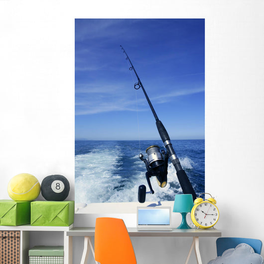 Fishing rod and reel on boat, fishing in blue ocean Wall Mural