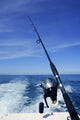 Fishing rod and reel on boat, fishing in blue ocean Wall Mural