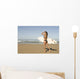 Young woman with surfboard on beach Wall Mural