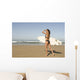 Young woman with surfboard on beach Wall Mural
