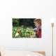 Toddler watering the flowers Wall Mural