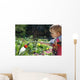 Toddler watering the flowers Wall Mural