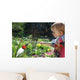 Toddler watering the flowers Wall Mural