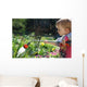 Toddler watering the flowers Wall Mural