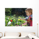 Toddler watering the flowers Wall Mural
