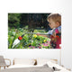 Toddler watering the flowers Wall Mural