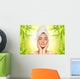 Beautiful young woman applying organic cosmetics to her skin Wall Mural
