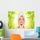 Beautiful young woman applying organic cosmetics to her skin Wall Mural
