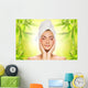 Beautiful young woman applying organic cosmetics to her skin Wall Mural