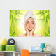Beautiful young woman applying organic cosmetics to her skin Wall Mural