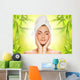 Beautiful young woman applying organic cosmetics to her skin Wall Mural