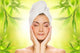 Beautiful young woman applying organic cosmetics to her skin Wall Mural