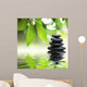 Zen stones pyramid on water surface, green leaves over it Wall Mural
