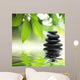 Zen stones pyramid on water surface, green leaves over it Wall Mural