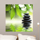 Zen stones pyramid on water surface, green leaves over it Wall Mural