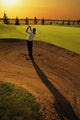 Golfer Taking A Swing From A Golf Bunker Wall Mural