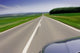 Fast moving car on road Wall Mural